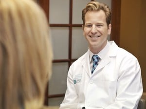 Doctor Kulbersh is giving consultation to a patient on neck-lift at his clinic in Charlotte, NC.