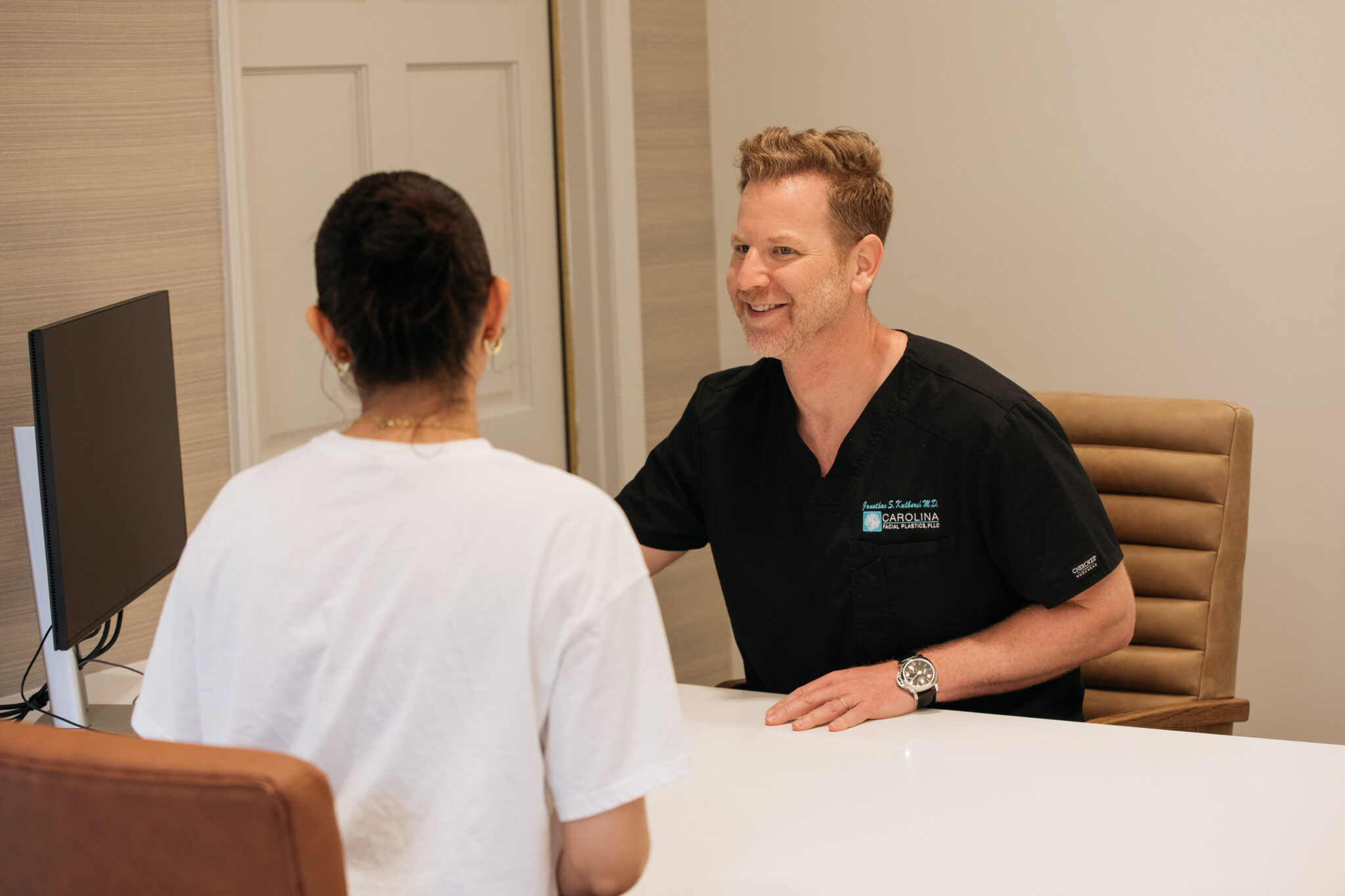 Dr. Kulbersh having consultation with patient