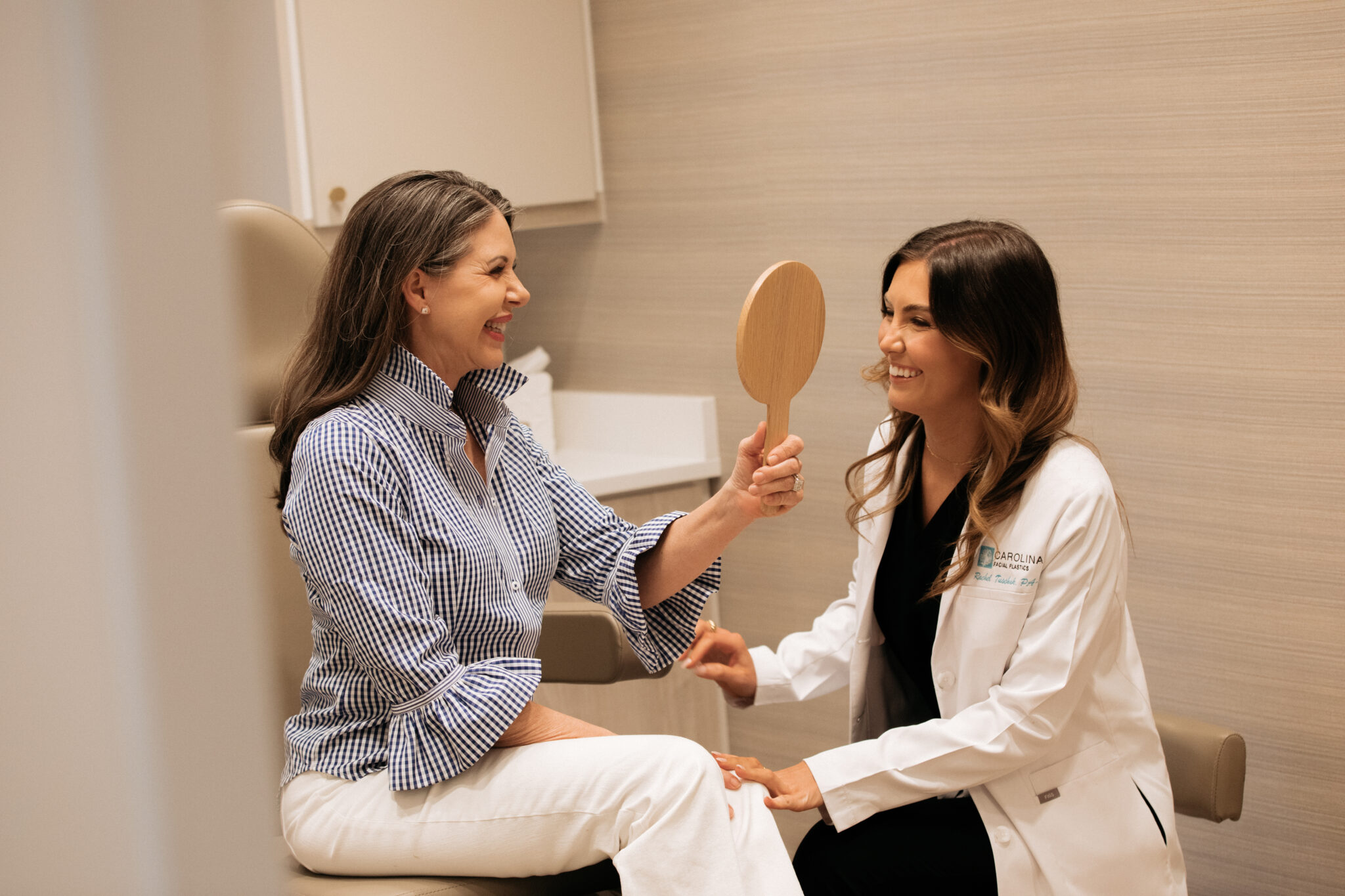 Provider with patient consulting over treatment for fine lines and wrinkles in Charlotte