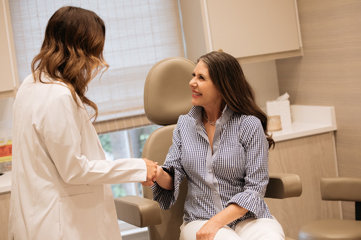 Female patient during a consultation with a doctor at carolina facial plastics