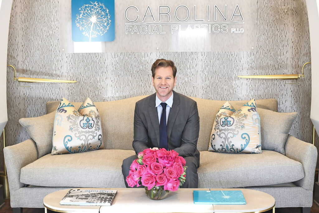 Dr. kulbersh sitting on a couch in his charlotte office