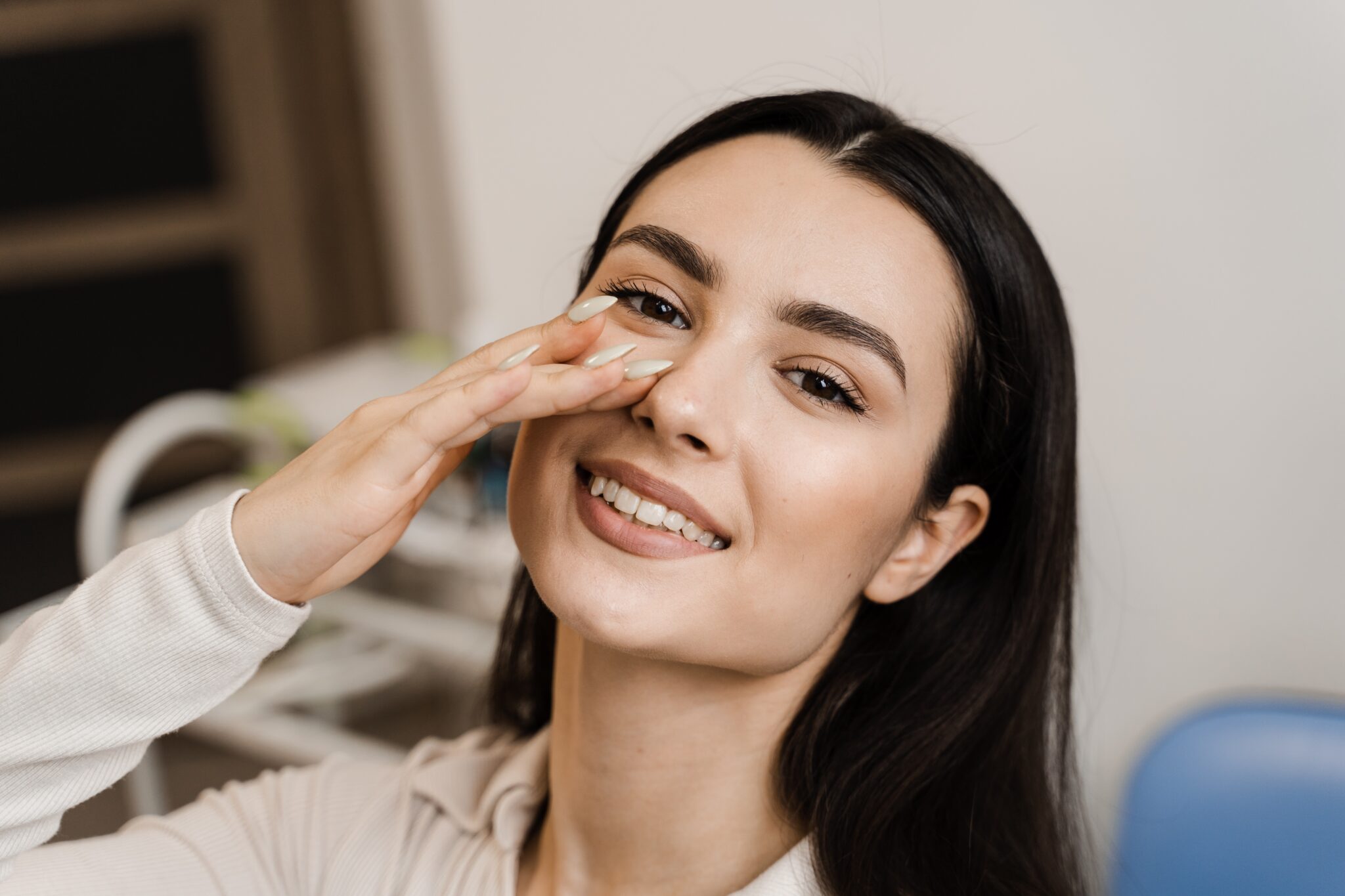 young woman touching her nose